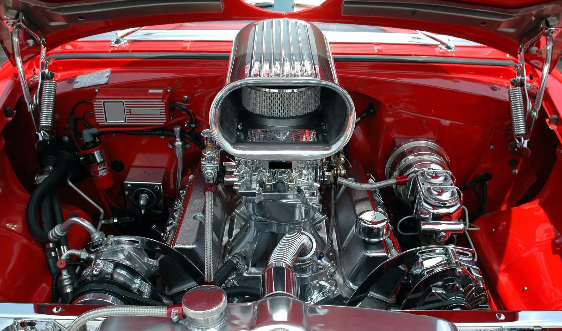 A close up of the engine on a red car