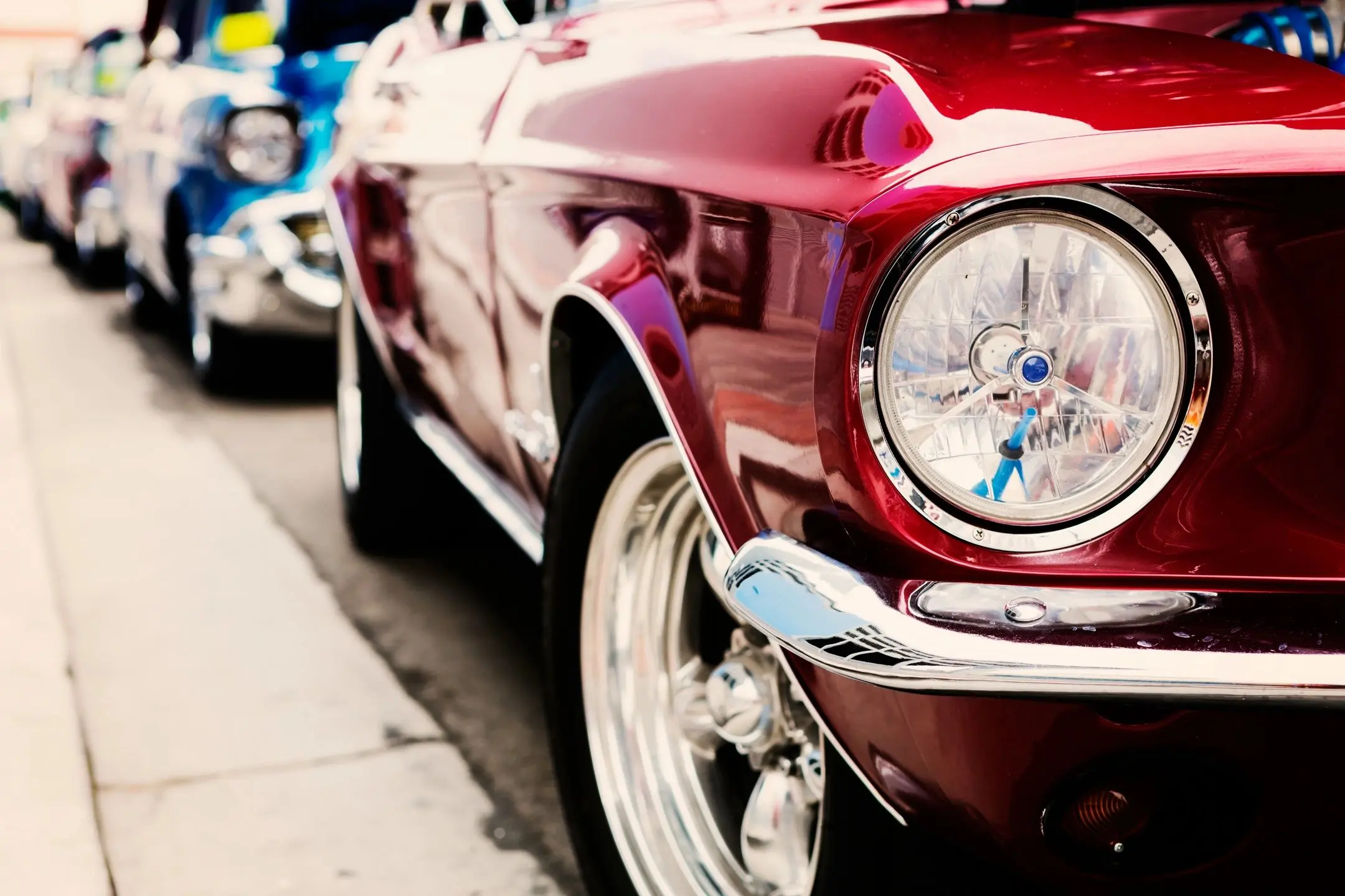 A close up of the front end of a red car